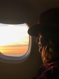 Close-up of woman seen through airplane window