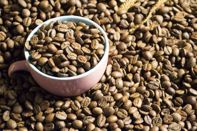 Close-up of roasted coffee beans in cup