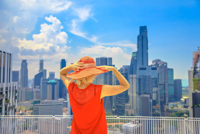 Woman standing against buildings in city