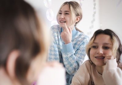 Smiling mother and daughter at home