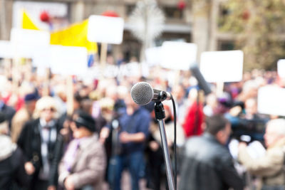 Close-up of microphone against crowd