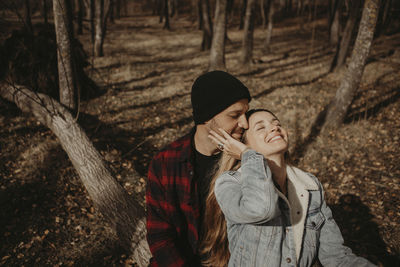 Couple kissing in forest