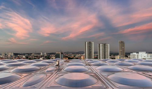 Modern buildings in city during sunset