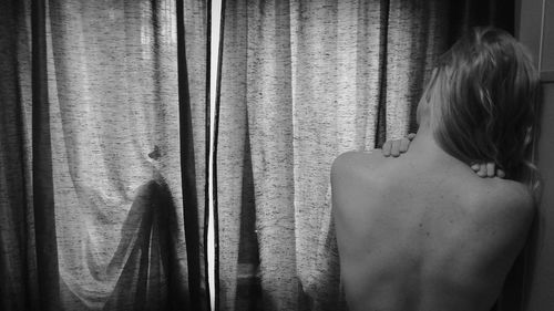 Rear view of shirtless woman