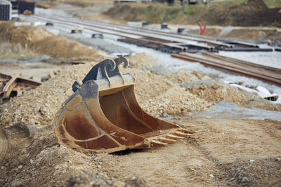 Building of railroad track. excavator bucket on construction site of new tram connection.