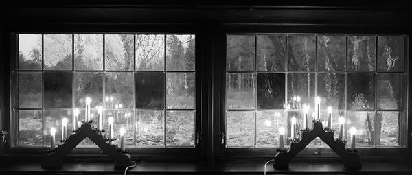 Silhouette people in glass window of building