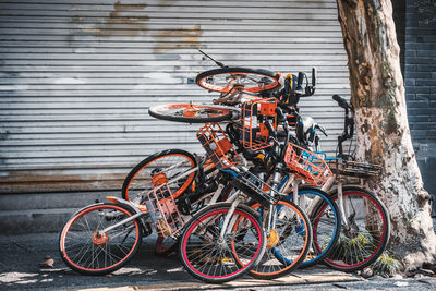 Bicycles parked on footpath by wall