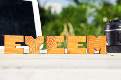 Close-up of wooden eyeem text against defocused background