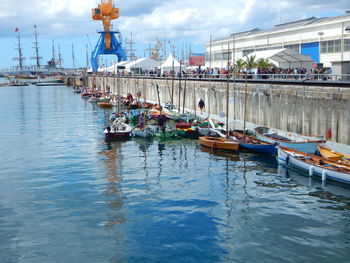 Boats in river with buildings in background