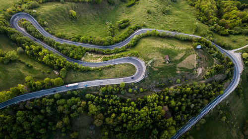 Aerial view of road amidst trees in forest