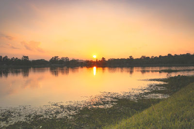 Scenic view of lake against sky during sunset