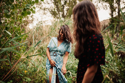 Woman standing by plants on land