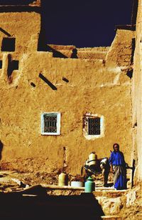 People sitting on old building