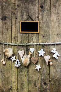 Christmas decorations hanging on wooden wall