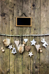 Close-up of christmas decorations hanging on wood