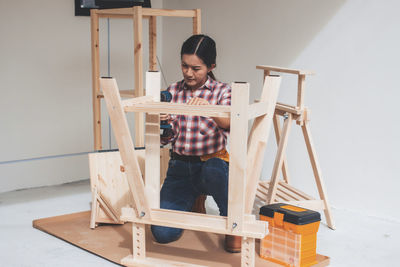 Full length of man sitting at home