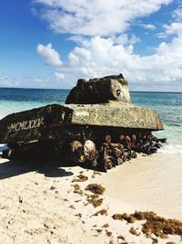 Scenic view of rocks on beach against sky