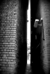 Narrow walkway along brick wall