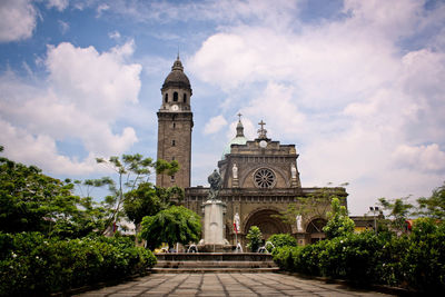 Exterior of cathedral against cloudy sky
