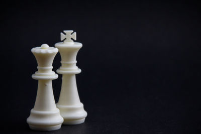 Close-up of chess pieces against black background