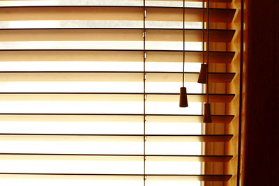 Full frame shot looking outside through timber ventian window blinds.