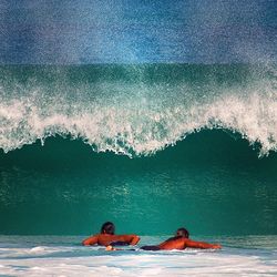 People surfing in sea