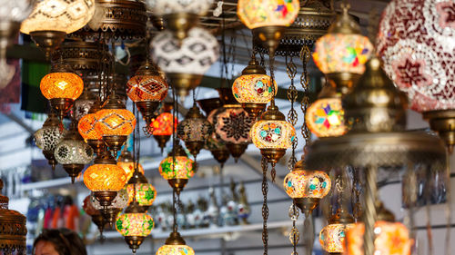 Illuminated lanterns hanging in store for sale in market