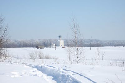 Lighthouse on snow covered landscape