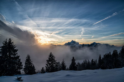 Scenic view of snow covered mountains against sky