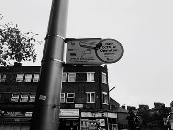 Low angle view of road sign against clear sky