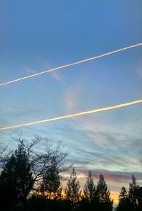 Low angle view of vapor trails in sky