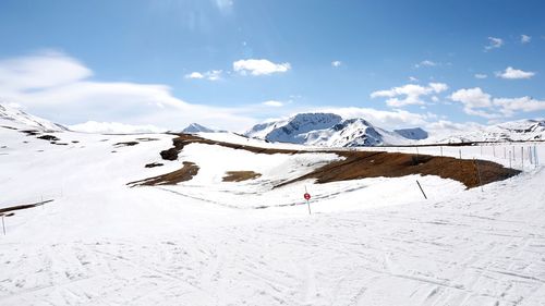 Scenic view of snow covered mountains against sky