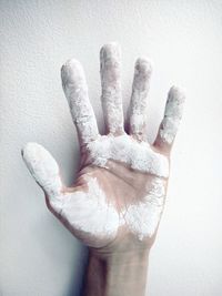 Close-up of human hand against white background