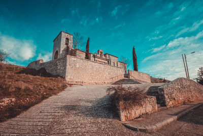 Low angle view of fort against blue sky