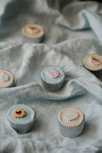 High angle view of cupcakes on fabric