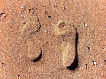 Close-up of footprint on sand