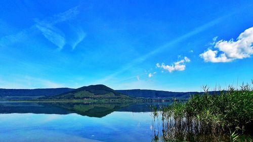 Scenic view of lake against blue sky