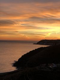 Scenic view of sea against orange sky