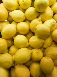 Fresh lemons on display in the market. lemon juice is used for culinary and non-culinary purposes. 