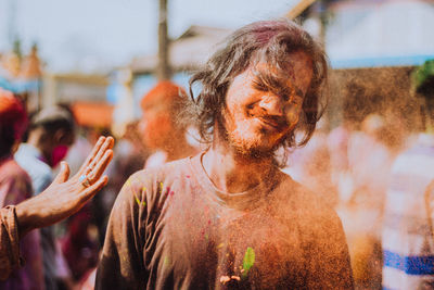 Portrait of young man during holi.