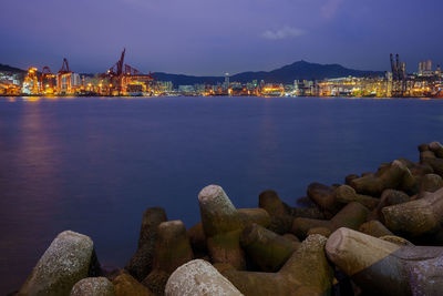 Scenic view of sea by buildings against clear sky