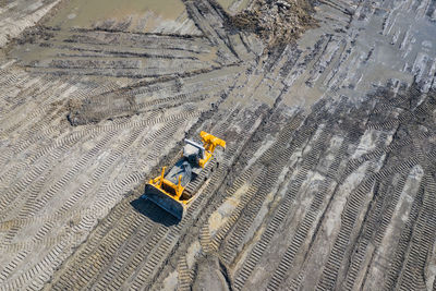 High angle view of tire tracks on field