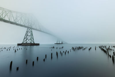 Bridge over sea against sky