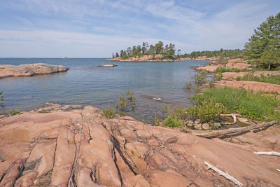 Worn granite rocks on a wilderness lakeshore on lake huron in killarney provincial park in ontario