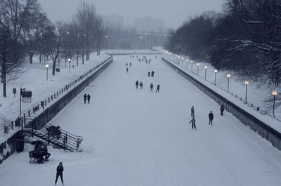 High angle view of people on snow covered field