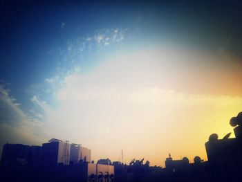 Low angle view of buildings against sky at sunset