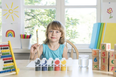 Portrait of happy girl on table