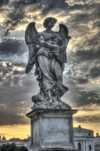 Low angle view of statue against cloudy sky