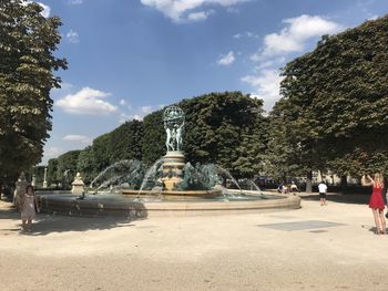 Statue in park against sky