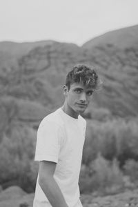 Portrait of young man standing on land